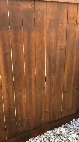 Tall stained wood privacy fence