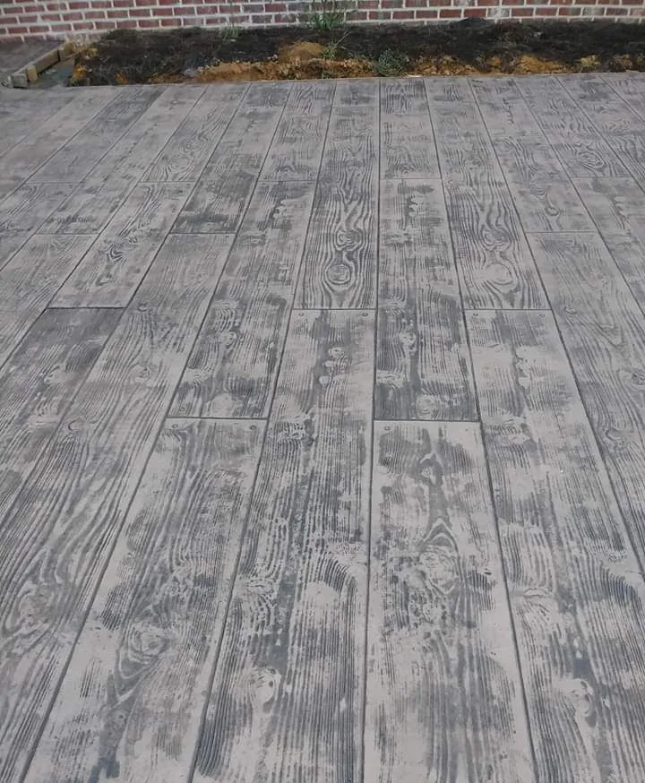 Wood-plank stamped concrete patio with realistic grain