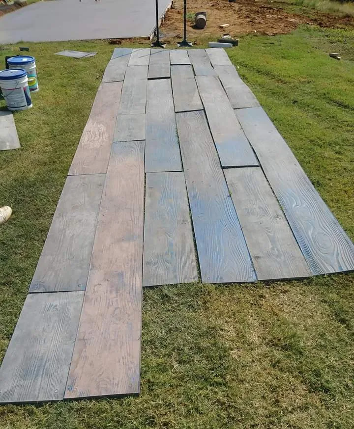 Wood-plank concrete stamps laid out during a project